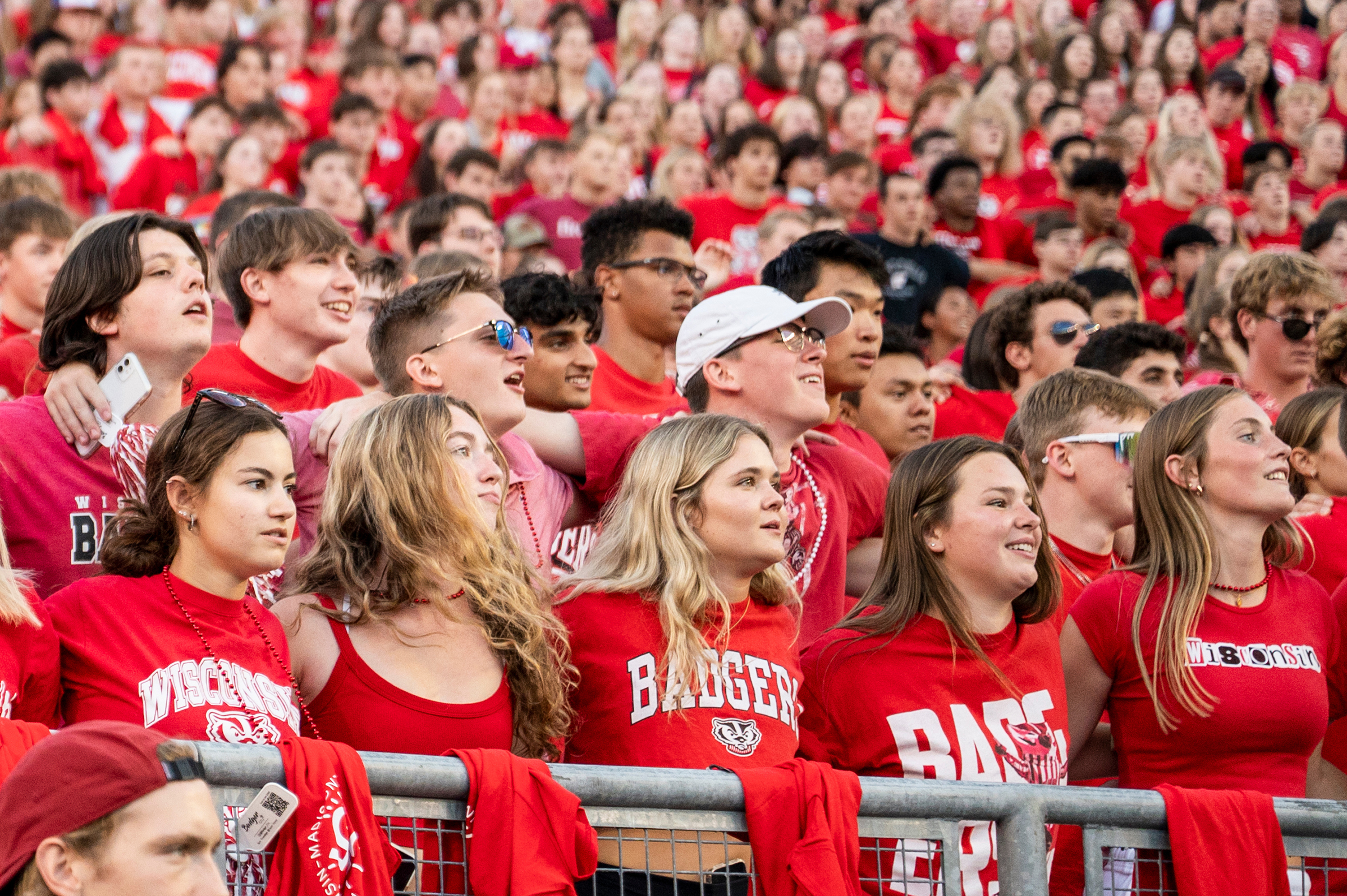 Large crowd of students shoulder-to-shoulder wearing Wisconsin Badger red attire.